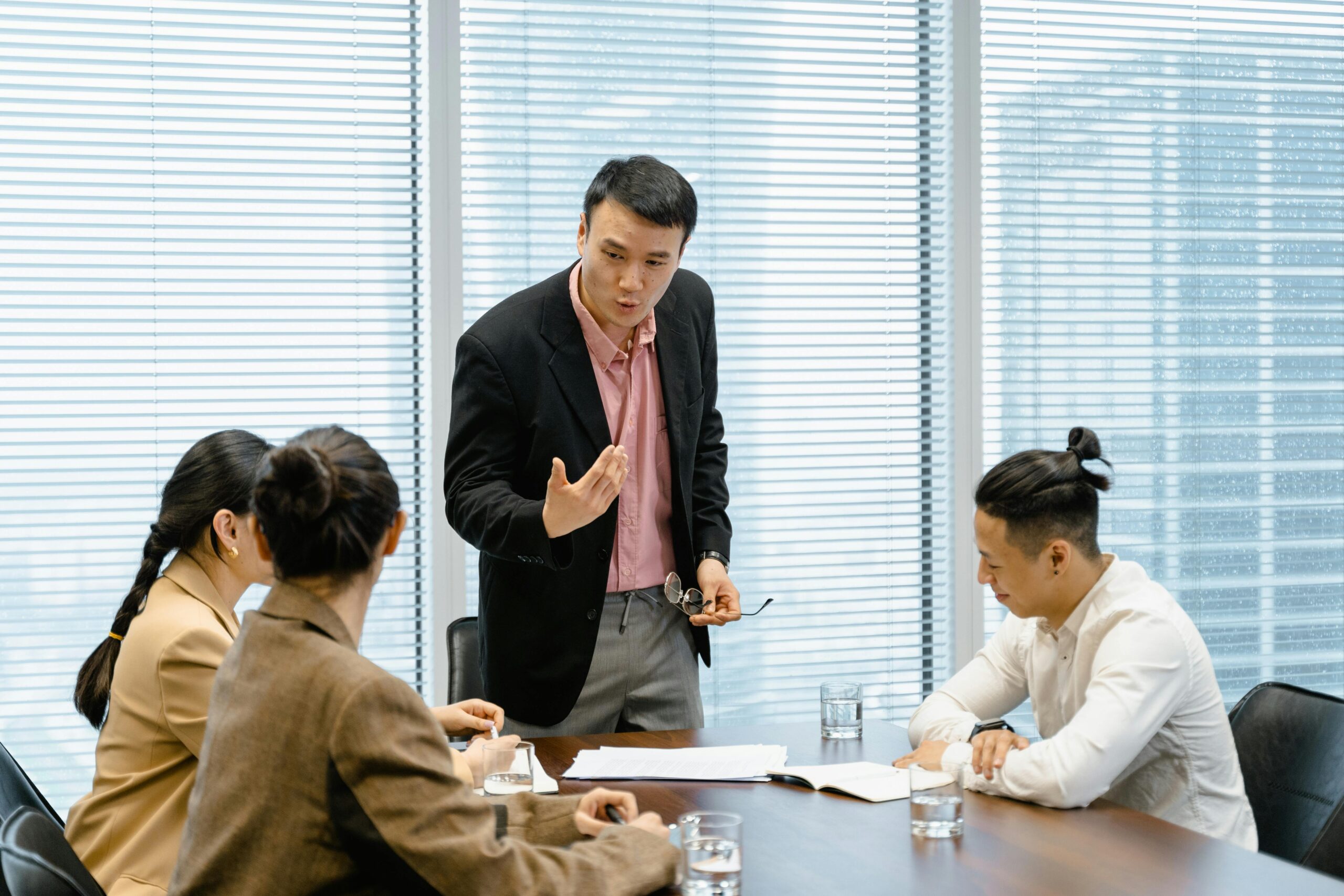 A group of professionals engaged in a business meeting in a modern office setting.